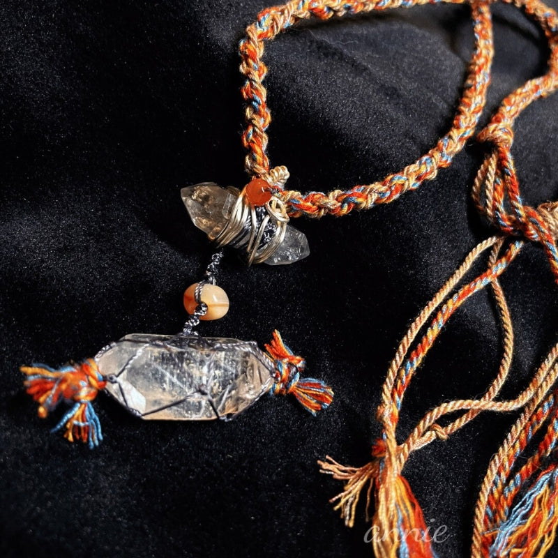 Close-up of braided white crystal necklace